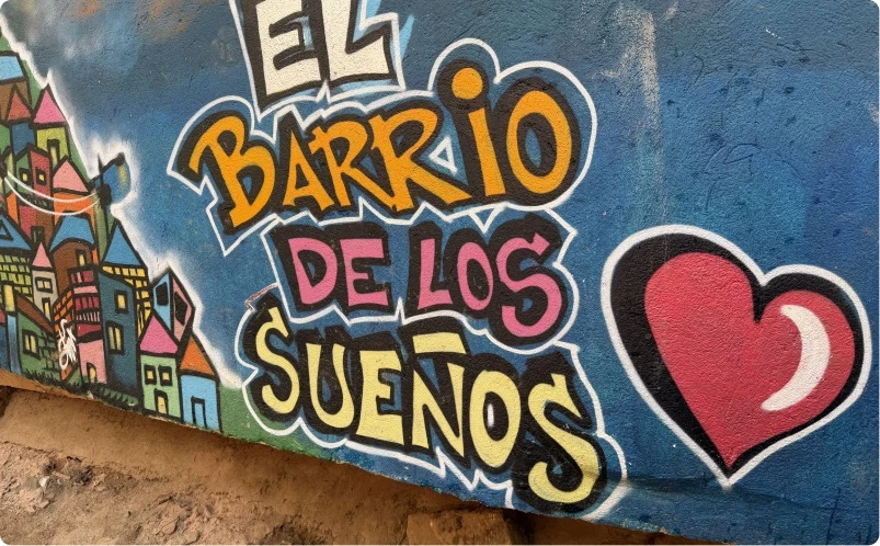 A vibrant community mural reading “El Barrio de los Sueños”